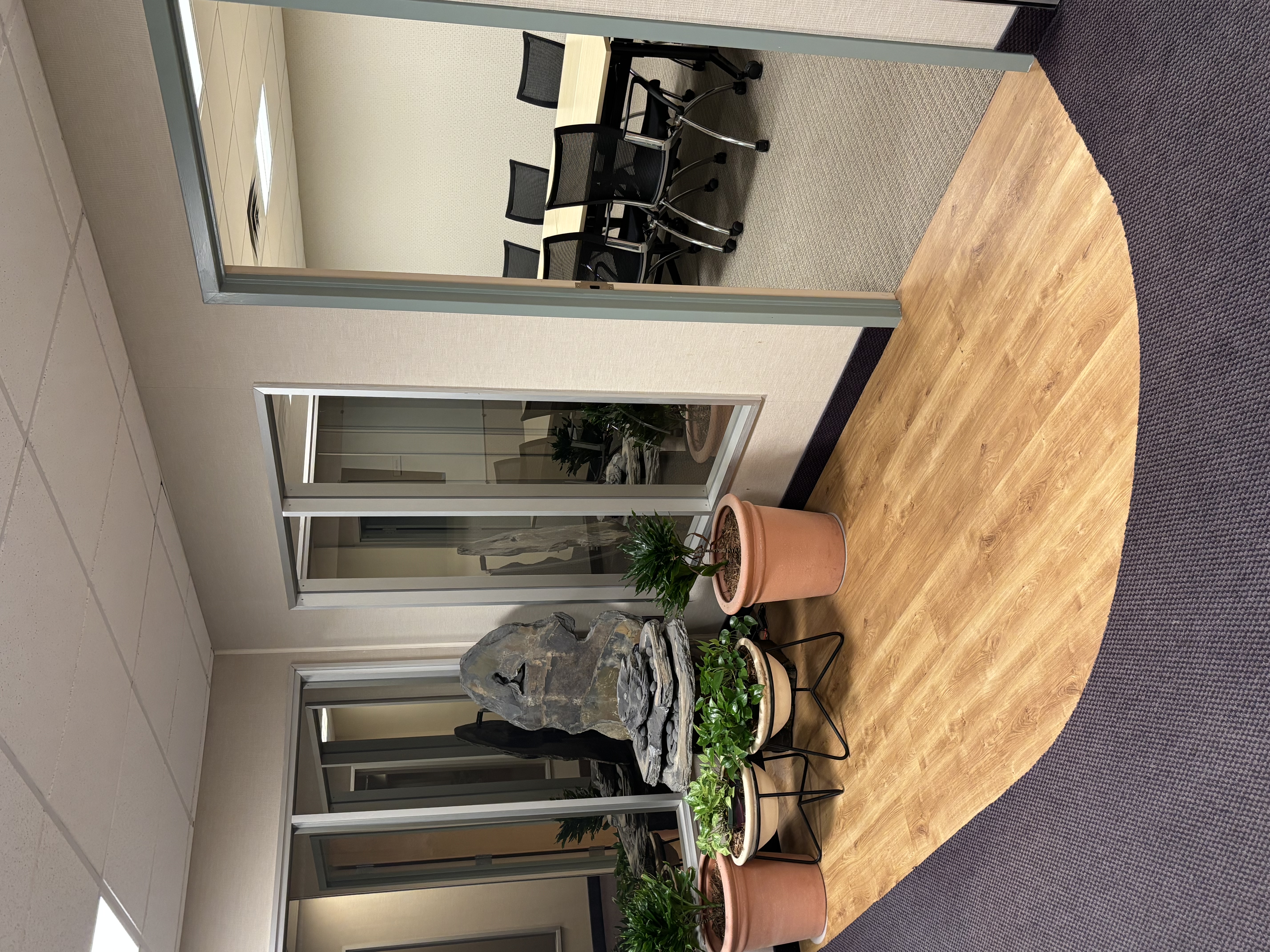 Plants and decorations outside an office meeting room.